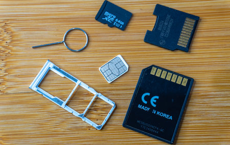 Close up of SD card and memory cards on wooden table background.