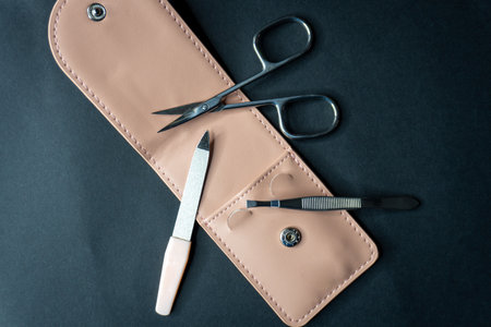 Set of tools for manicure and pedicure on a black background
