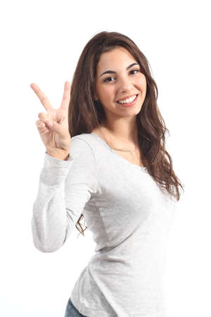 Young beautiful woman making victory sign on a white isolated backgroundの写真素材