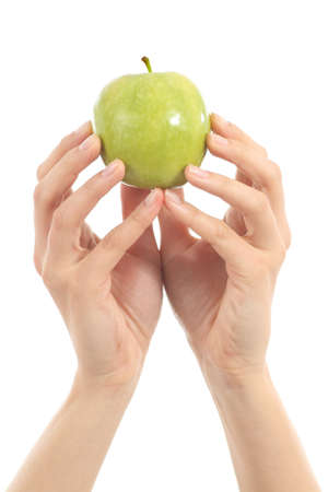Hands of a woman with an apple on a white isolated backgroundの写真素材