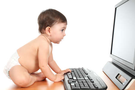 Baby typing on a computer keyboard in a white isolated backgroundの写真素材
