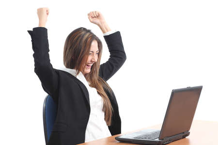 Euphoric business woman watching a laptop on a white isolated background                の写真素材