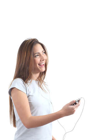 Woman singing and  listening to the music with headphones on a white isolated background                 の写真素材