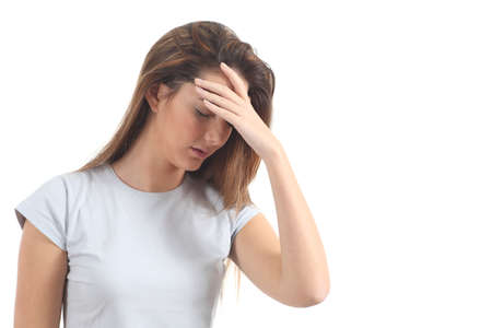 Woman with a headache and her hand in forehead on a white isolated backgroundの写真素材