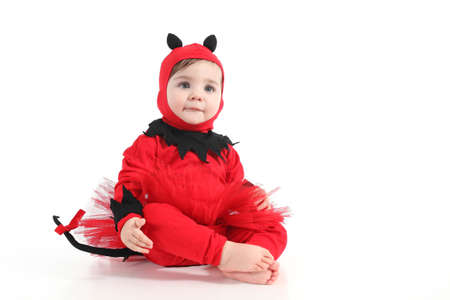 Baby with a red demon disguise  on a white isolated background        の写真素材