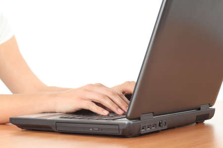 Beautiful woman hands typing on a laptop on an office table in a white isolated background               の写真素材
