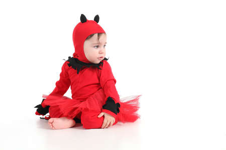 Baby with a red demon disguise  on a white isolated background        の写真素材