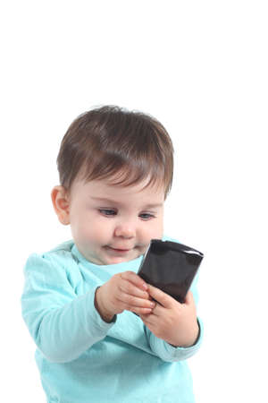 Baby playing with a mobile phone on a white isolated background             の写真素材