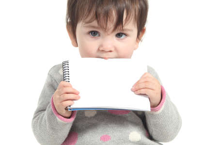 Baby biting a blank notebook on a white isolated background                