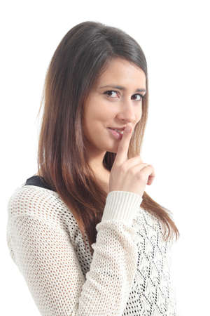 Beautiful woman asking for silence with forefinger on a white isolated background           の写真素材