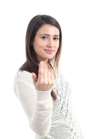 Beautiful woman making a beckoning gesture on a white isolated backgroundの写真素材