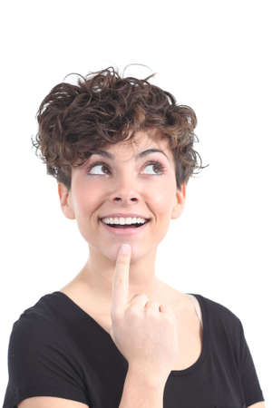 Woman smiling with her eyes looking above on a white isolated backgroundの写真素材