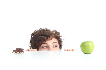 Beautiful woman choosing the apple on a white isolated backgroundの写真素材