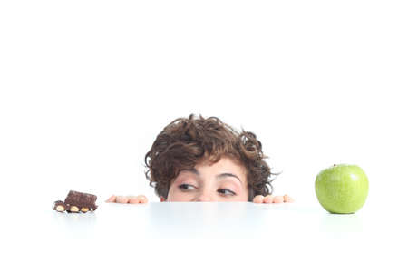 Beautiful woman choosing chocolate on a white isolated backgroundの写真素材