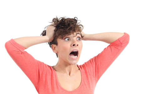 Hysterical woman expression with her hands on the head on a white isolated background             の写真素材