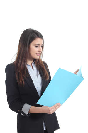 Beautiful businesswoman reading a report from a blue folder on a white isolated backgroundの写真素材
