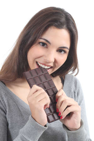 Beautiful woman eating chocolate on a white isolated backgroundの写真素材