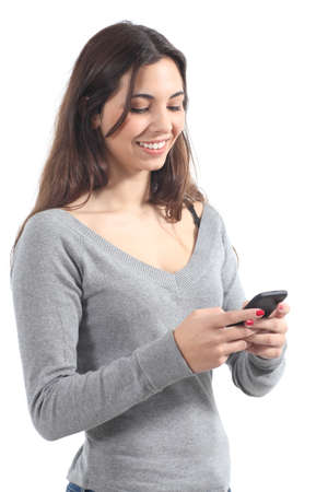 Beautiful girl sending a message with a mobile phone in a white isolated background               の写真素材