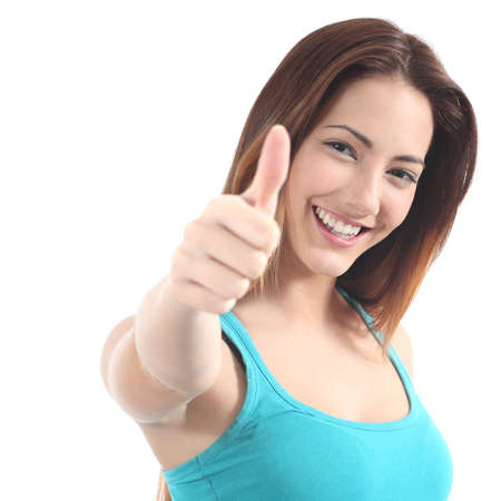 Portrait of a beautiful teen with thumb up gesture on a white isolated backgroundの写真素材