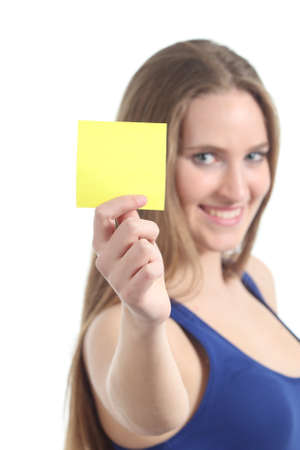 Woman holding and showing a blank yellow paper note on a white isolated background            の写真素材