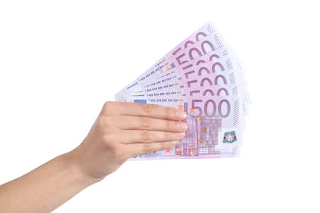 Woman hand paying a lot of five hundred euro banknotes on a white isolated background