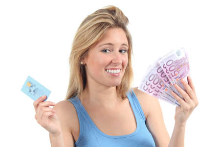 Woman doubting between money and credit card isolated on a white backgroundの写真素材