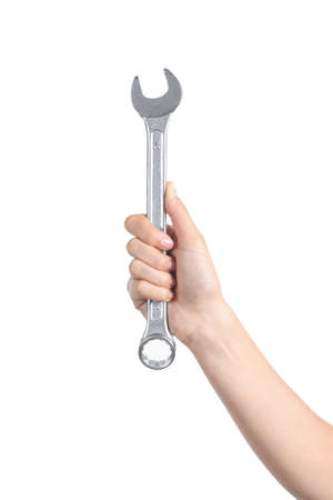 Woman hand holding a spanner isolated on a white background              の写真素材