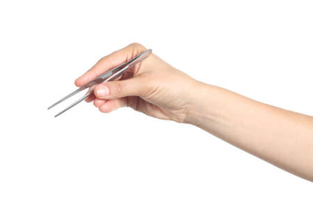 Woman hand using a small tweezers isolated on a white backgroundの写真素材