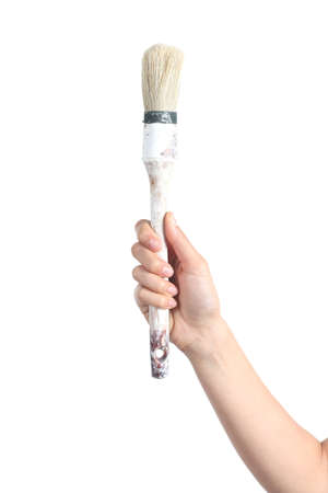 Woman hand holding an old paintbrush ready to paint isolated on a white background              の写真素材