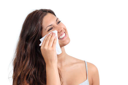 Attractive woman cleaning her face with a face wipe isolated on a white background         の写真素材