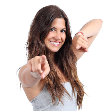 Close up of a beautiful teenager smiling and pointing at camera on a white isolated background