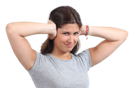 Beautiful woman covering her ears with her hands isolated on a white background     の写真素材