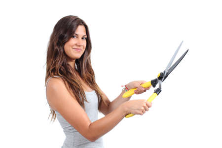 Beautiful woman holding a pruning shears isolated on a white background               の写真素材