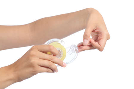 Woman hand holding and using transparent adhesive tape isolated on a white background           