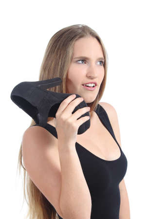 Blonde woman talking on the phone using a heel on the ear isolated on a white backgroundの写真素材