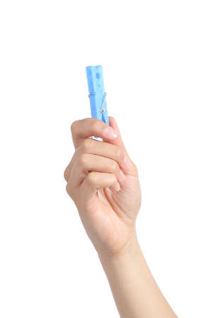 Front view of a woman hand holding a clothespin isolated on a white background               の写真素材