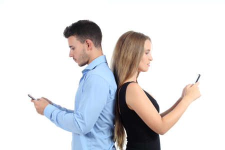 Attractive couple typing in their mobile phones isolated on a white background