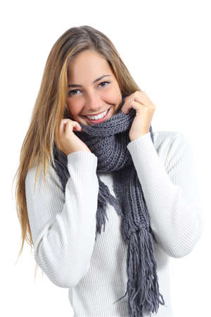 Happy beautiful woman keeping warm in a sweater in a cold winter isolated on a white background