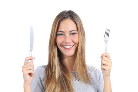 Beautiful woman holding a fork and a table knife isolated on a white background                の写真素材
