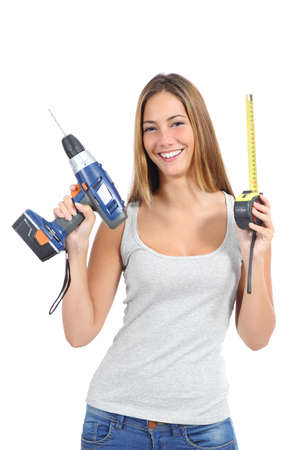 Beautiful woman holding a power drill and a tape measure isolated on a white background                の写真素材