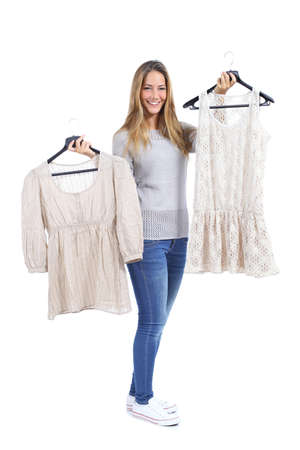 Happy woman shopping and choosing clothes isolated on a white backgroundの写真素材