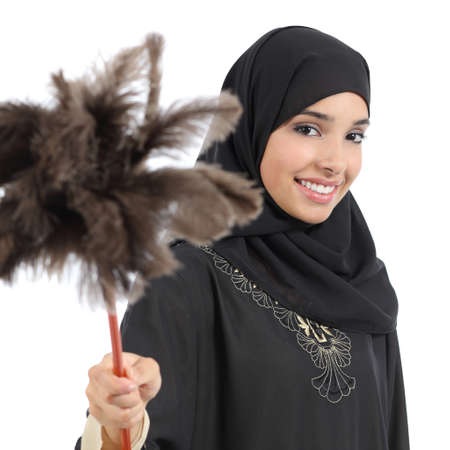 Arab housewife woman smiling and holding a duster clean isolated on a white の写真素材