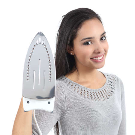 Beautiful young housewife holding a smoothing iron isolated on a white backgroundの写真素材