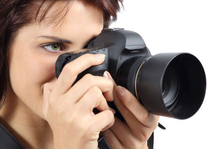 Beautiful photographer woman holding a digital camera isolated on a white background             の写真素材