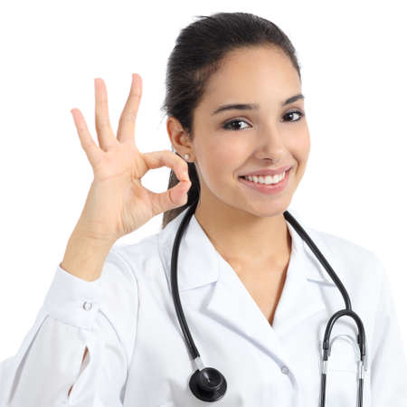 Beautiful young doctor woman smiling and gesturing ok isolated on a white background              の写真素材