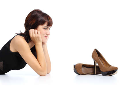 Beautiful woman looking a high heels stiletto shoes isolated on a white background       の写真素材