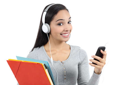 Arab student listening to the music and holding folders isolated on a white background            の写真素材