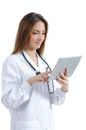 Beautiful female doctor browsing a tablet pc while she is working isolated on a white backgroundの写真素材