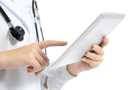 Close up of a woman doctor hand touching a tablet pc isolated on a white background              の写真素材