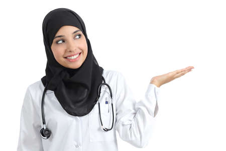 Arab doctor woman presenting with palm up isolated on a white background       の写真素材